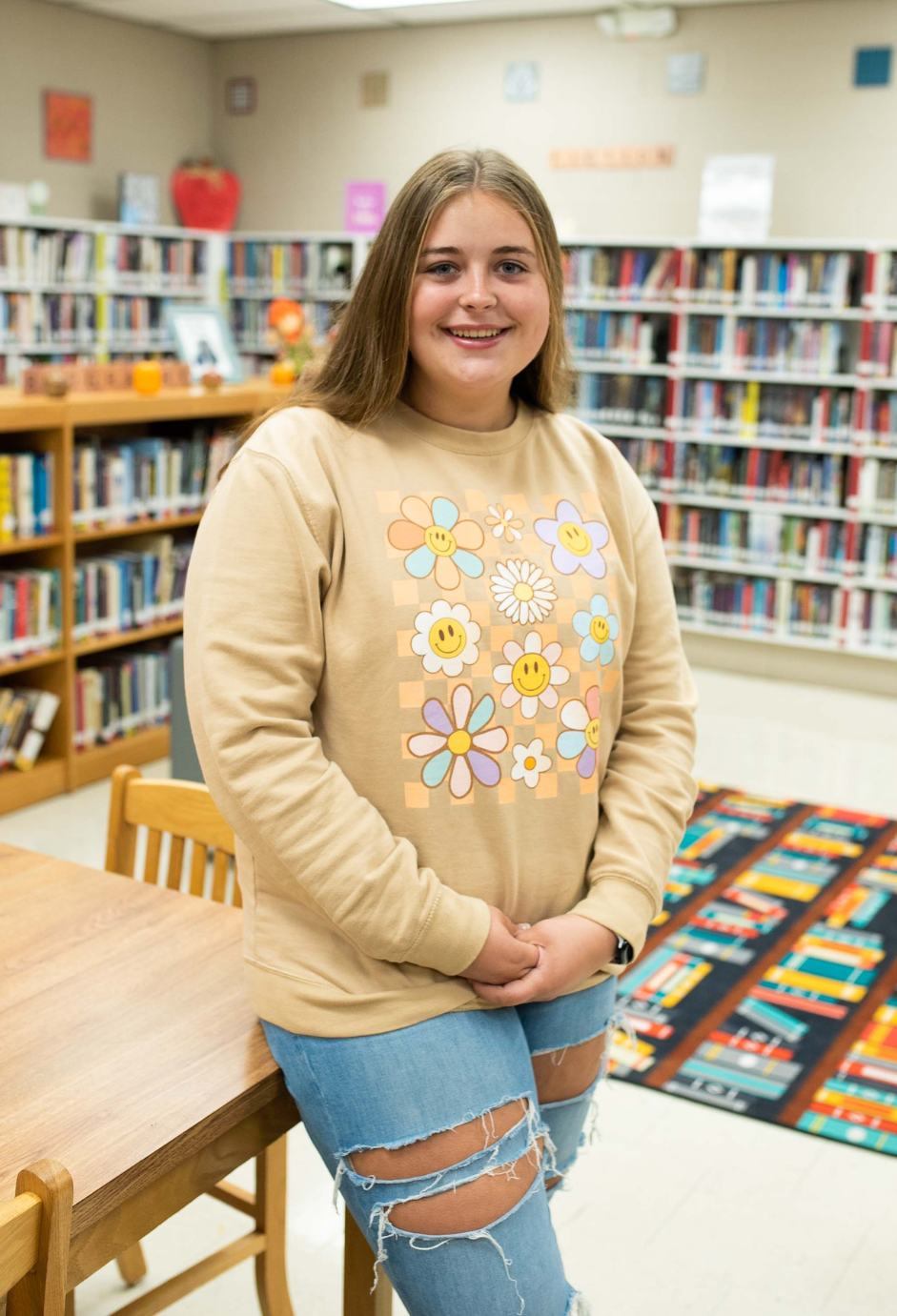 A student standing in a library.